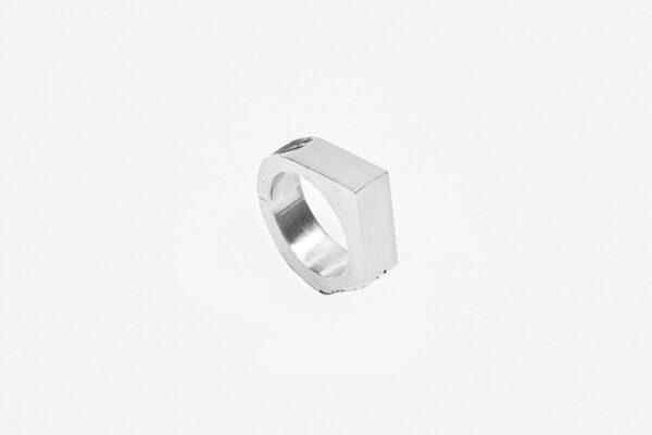 Inel geometric din argint 925 fotografiat dintr-un unghi creativ – bijuterie sculpturală cu personalitate.