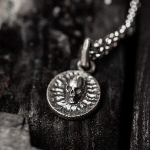 Pandantiv Mini Skull Argint 925, sculptat manual prin tehnica cerii pierdute. Design gotic cu craniu distinctiv și dinți definiți, logo Silver Craft cu dragon și șarpe, simbol al puterii și echilibrului. Accesoriu ideal pentru stiluri dark, goth și rock.